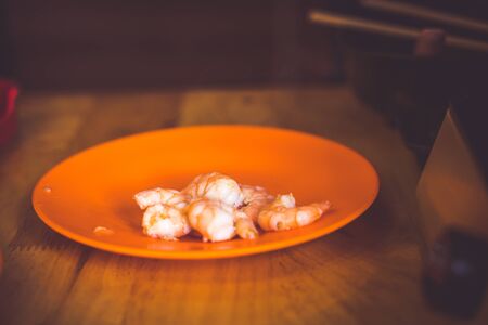 The Raw whole fresh uncooked prawns shrimps on stone red plateの写真素材