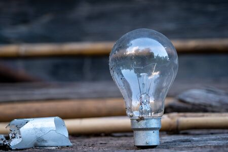 The Light bulb standing on wood - Concept of saving energy and have a big idea.の写真素材