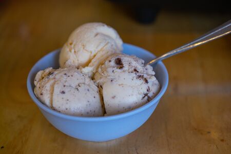 The different flavor ice cream scoops side view on wooden table backgroundの写真素材