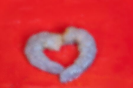 The blur focus of heart shape on red background, valentine conceptの写真素材