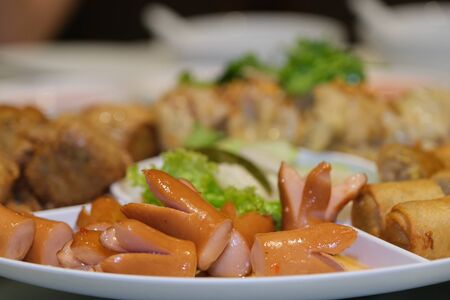 The Sliced on a plate in the form of ham sausage and vegetables in a restaurant, appetizer.の写真素材