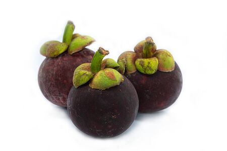 Three Mangosteen (Garcinia mangostana) is an exotic, tropical fruit with a slightly sweet and sour flavor, isolated on white background.の写真素材