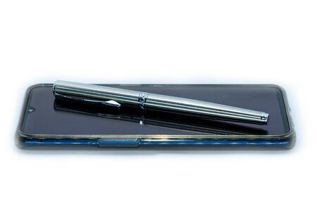 The luxury pen on a smart phone on white Background.の写真素材