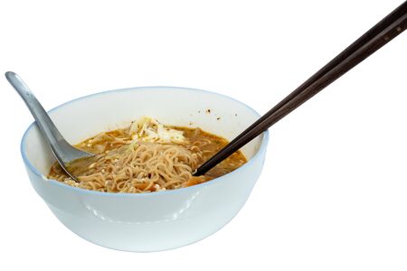 The Instant noodle with spoon and chopsticks in a white ceramic bowl isolated on white.の写真素材