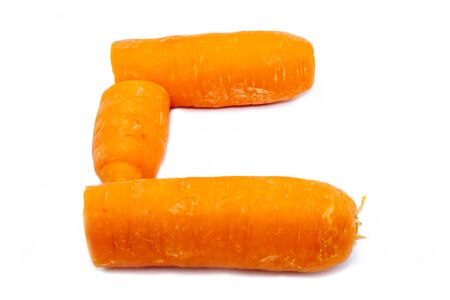The C is a carrot. Bright capital letter C made of round carrot slices at white backgroundの写真素材