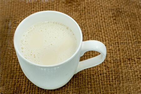 A glass of milk on sack background and space for putting textの写真素材