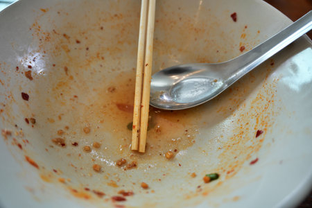 Empty blow after eating finished. empty blow with chopstick.の写真素材