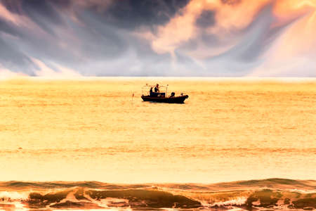 Fishing boat nets posing at sunset in south China sea in the Hainan island coastの写真素材