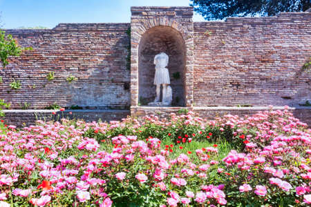 Glimpse of the Domus della Fortuna Annonaria courtyard ruins and Diana statue in the archaeological area of Ostia Antica - Romeの写真素材