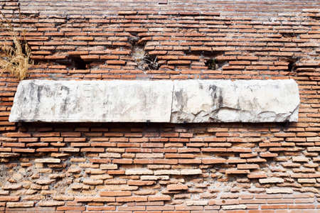 Archaeological excavations in Ostia Antica: Roman wall with marble engraved with Latin letters.の写真素材