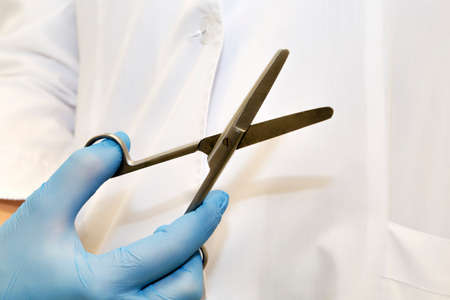 Surgical scissors close up with medical gown background - selective focusの写真素材