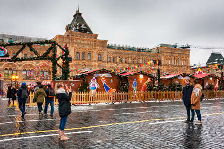 Moscow, Russian Federation - January 28, 2017 :The Moscow Kremlin,Tourists take pictures and walking aronud  Red Square, in backgorund, the view of the famous facade of GUM State Department Storesのeditorial素材