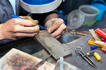 Goldsmith at work with traditional tools - selectived focus