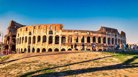 Rome, Italy - June 30, 2018: View of the Colosseum adjacent to Via Dei Fori Imperiali in a summer evening with many tourists enjoying the beauties of Rome.のeditorial素材