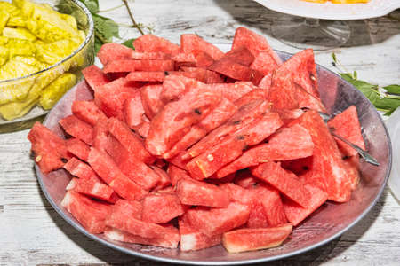 Serving dish with many slices of cold watermelon ready to eat - selective focusの写真素材