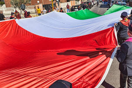 Rome,Italy - September 30, 2018: In occasion of the 50th anniversary of the foundation of the National Association of Italian State Police a huge Italian tricolor flag is carried by hand between the streets.のeditorial素材