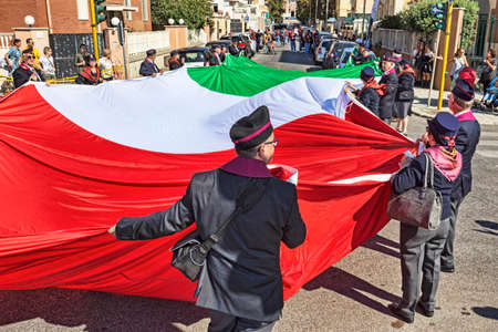 Rome,Italy - September 30, 2018: In occasion of the 50th anniversary of the foundation of the National Association of State Police a huge Italian tricolor flag is carried by hand between the streets.のeditorial素材