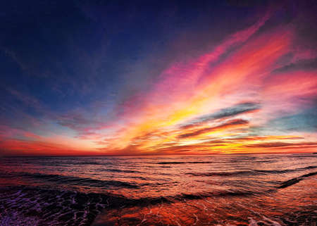 Awesome golden hour sunset over the beach with wonderful pastel colored sky