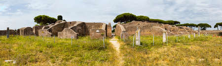 Panoramic view in 180 degrees in the Roman empire village ruins in Ostia Antica with the gym of Neptune spa at archaeological excavation - Romeの写真素材