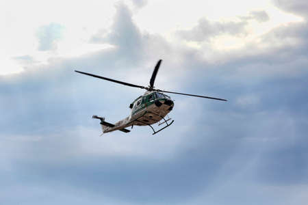 Ostia Lido Rome; Italy - July 15; 2019: Helicopter of italian military force Carabinieri patrols Rome's street from the sky on a cloudy day. The Italian Carabinieri is first Armed Forces of the Italian State Armyのeditorial素材