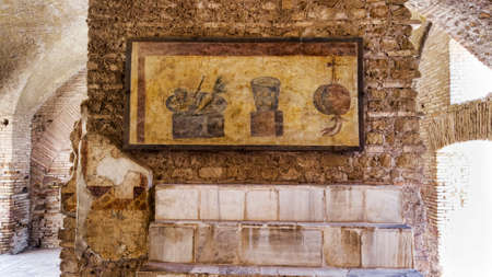 Roman empire archaeological excavations in Ostia Antica with the interior of the Termopolio s tenement and the marble shelf surmounted with decorative still life frescoes.  Rome , Italyの写真素材