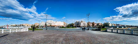 Rome, Italy - November 19, 2020: Panorama from Pier to Ravennati Square with waterfront Paolo Toscanelli and Marina's avenue, with historic buildings facades of commercial establishments and hotels, people walking and enjoy a beautiful sunny winter dayのeditorial素材