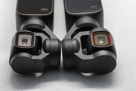 Rome, Italy - December 03, 2020: Close up view tree of three-axis gimbal stabilize compact cameras produced by DIJ. On left picture Osmo Pocket lens and on right Pocket 2 lens, the evolution of the firstone.のeditorial素材