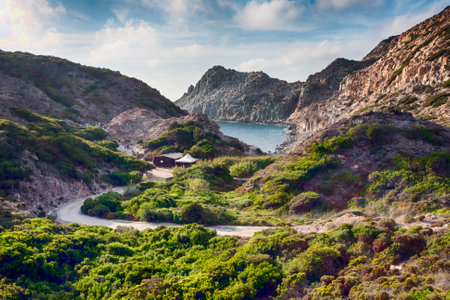 Panoramic view at wild bay with high cliffs and typical mediterranean vegetation and blue seaの写真素材