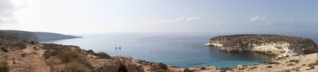 Pure crystalline water surface around an island (Lampedusa)の写真素材