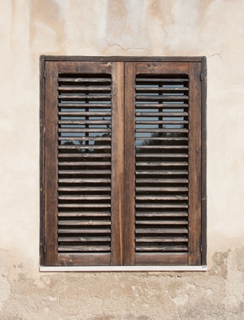 Closed wood window on aged brick wall backgroundの写真素材