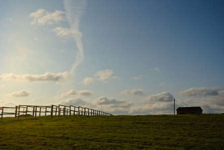 Fenced meadow with shelter in itの写真素材