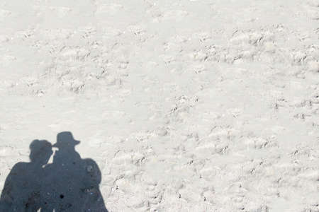 Shadows on the sand men and women on a beach holiday