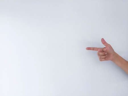 The hand of a young woman pointing with her index finger at an empty space.の写真素材