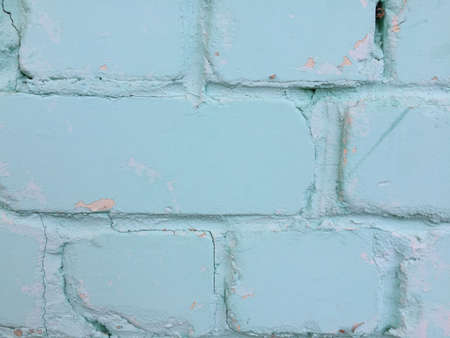 Background of blue brick wall texture with peeling paint. Close up.の写真素材