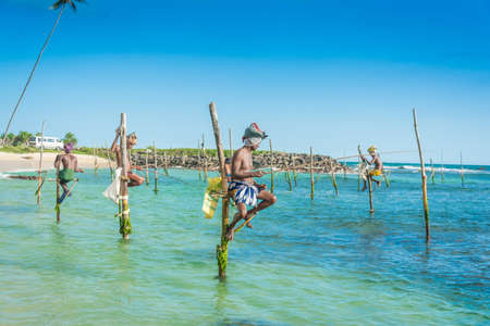 Silhouettes of the traditional fishermen at daytime in Sri Lanka pictured on 24th March 2013 at Koggala, Sri Lanka.のeditorial素材