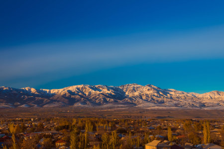 Picturesque chain of mountain alps partially covered by snow at sunset, late fallの写真素材