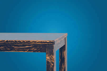 Part of empty wooden table isolated on blueの写真素材