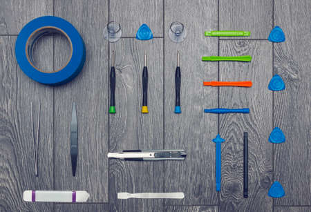 Flat lay of set of hand tools for DIY repairs on wooden surface