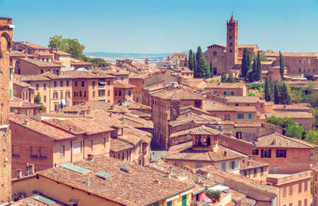 Beautiful italian town Siena with narrow lanes and streets and old roofs top view from above