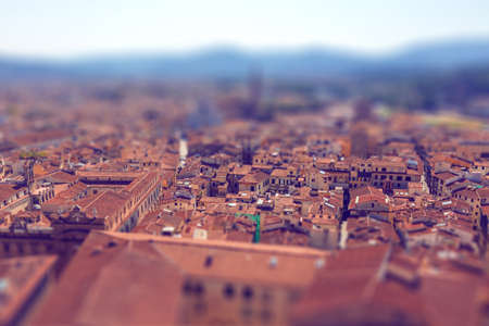 Tilt-shift effect of beautiful italian town Florence with narrow lanes and streets and old roofs top...