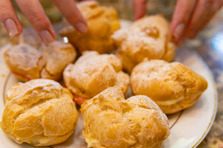 Process of cooking custard cakes by woman at domestic kitchenの写真素材