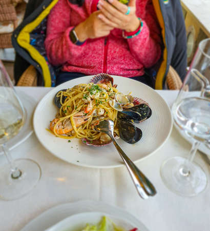 Selective focus of seafood pasta, mediterranean food, mobile photoの写真素材