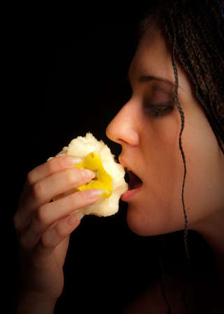 girl eating apple over the black background