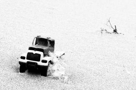 Toy car in sand の写真素材