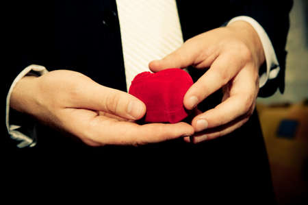 Man in suit holding engagement ringの写真素材