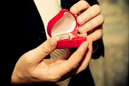 Man in suit holding engagement ringの写真素材