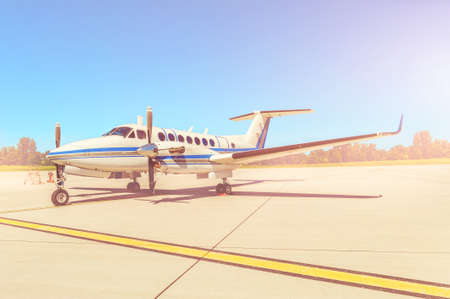 Propeller plane parking at the airport. Sunny day.