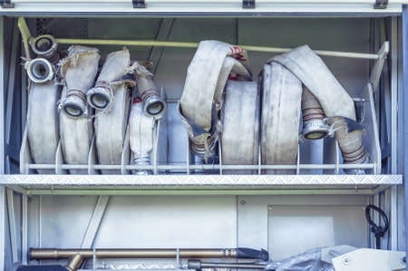 Equipment of Fire Truck: heavy duty water hoses in a firefighter vehicle