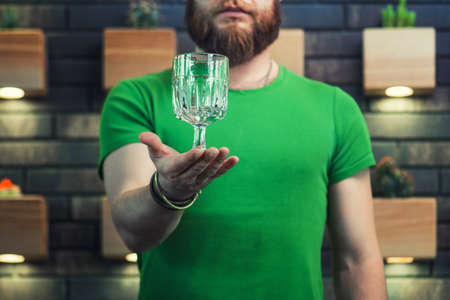 Man with beard holding coctail glass close upの写真素材