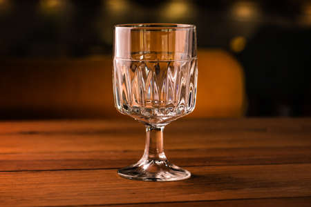 Empty coctail glass on table in night clubの写真素材